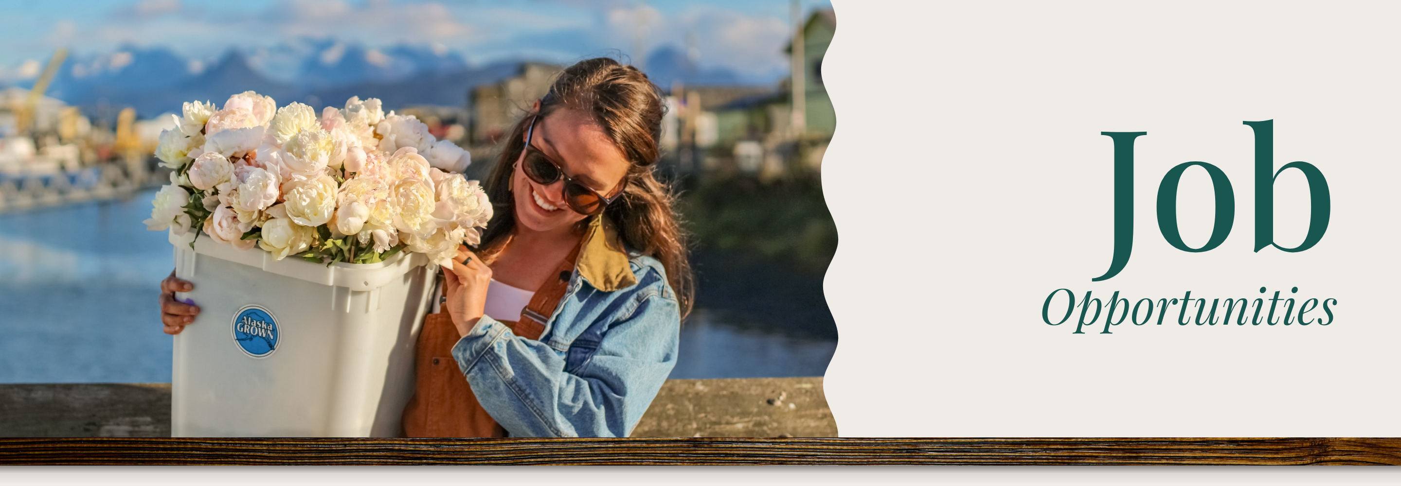 Woman holding a large flower bucket with scenic background and 'Job Opportunities' text overlay | Alaska Beauty Peony Cooperative | Homer, AK
